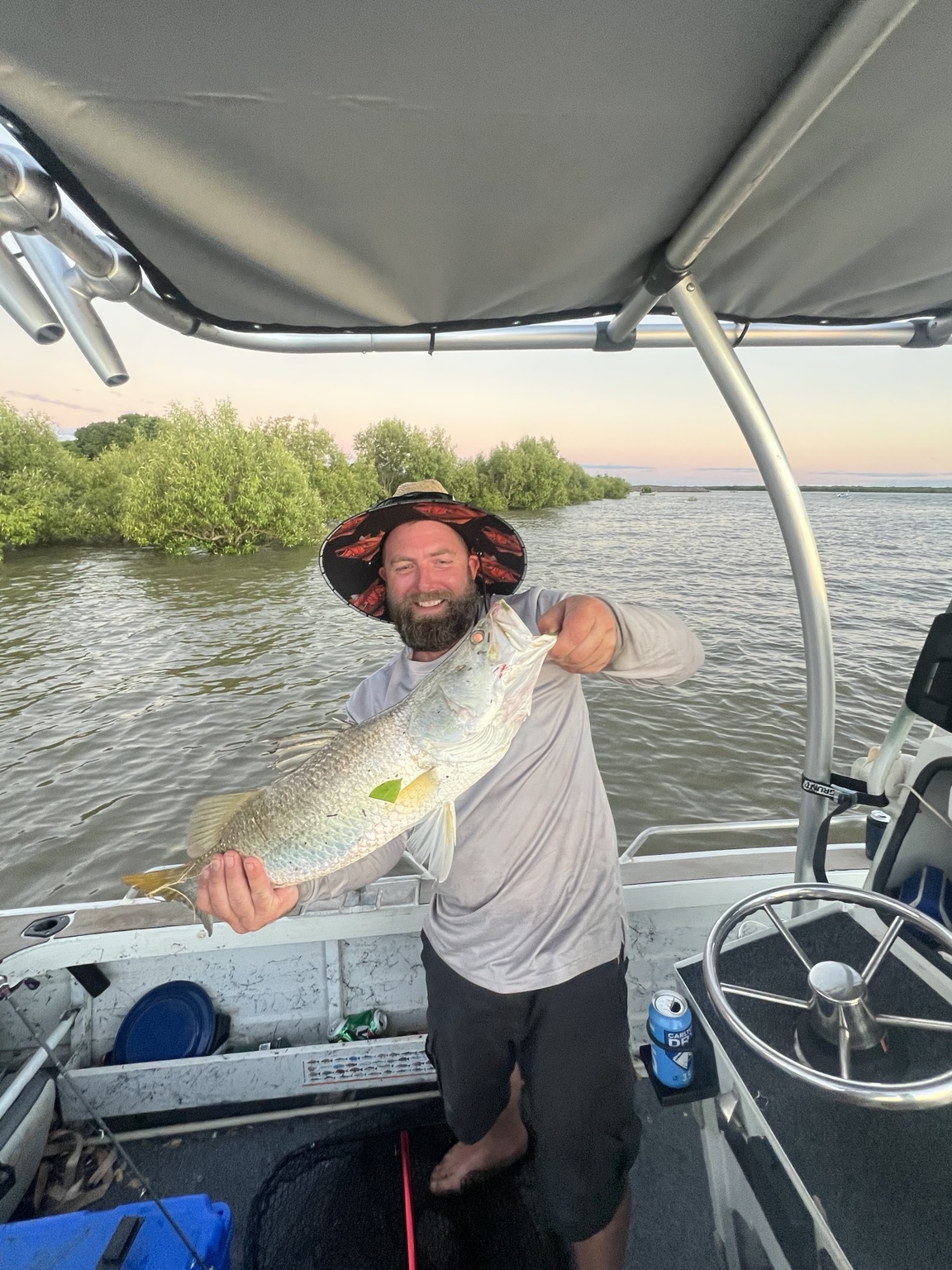 Glenn holding a barramundi from the boat