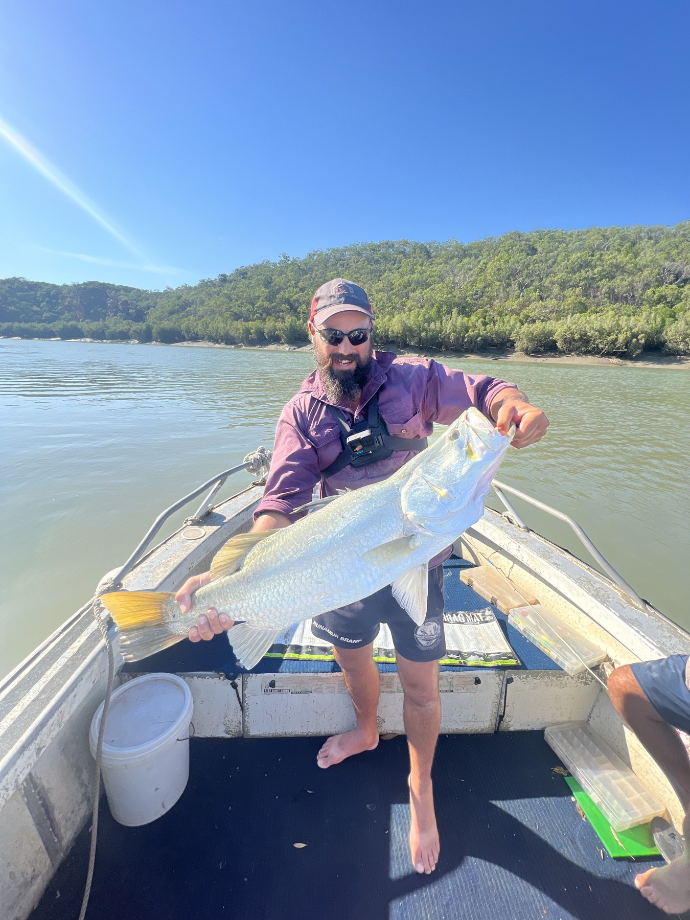 Glenn holding a big barramundi on the boat