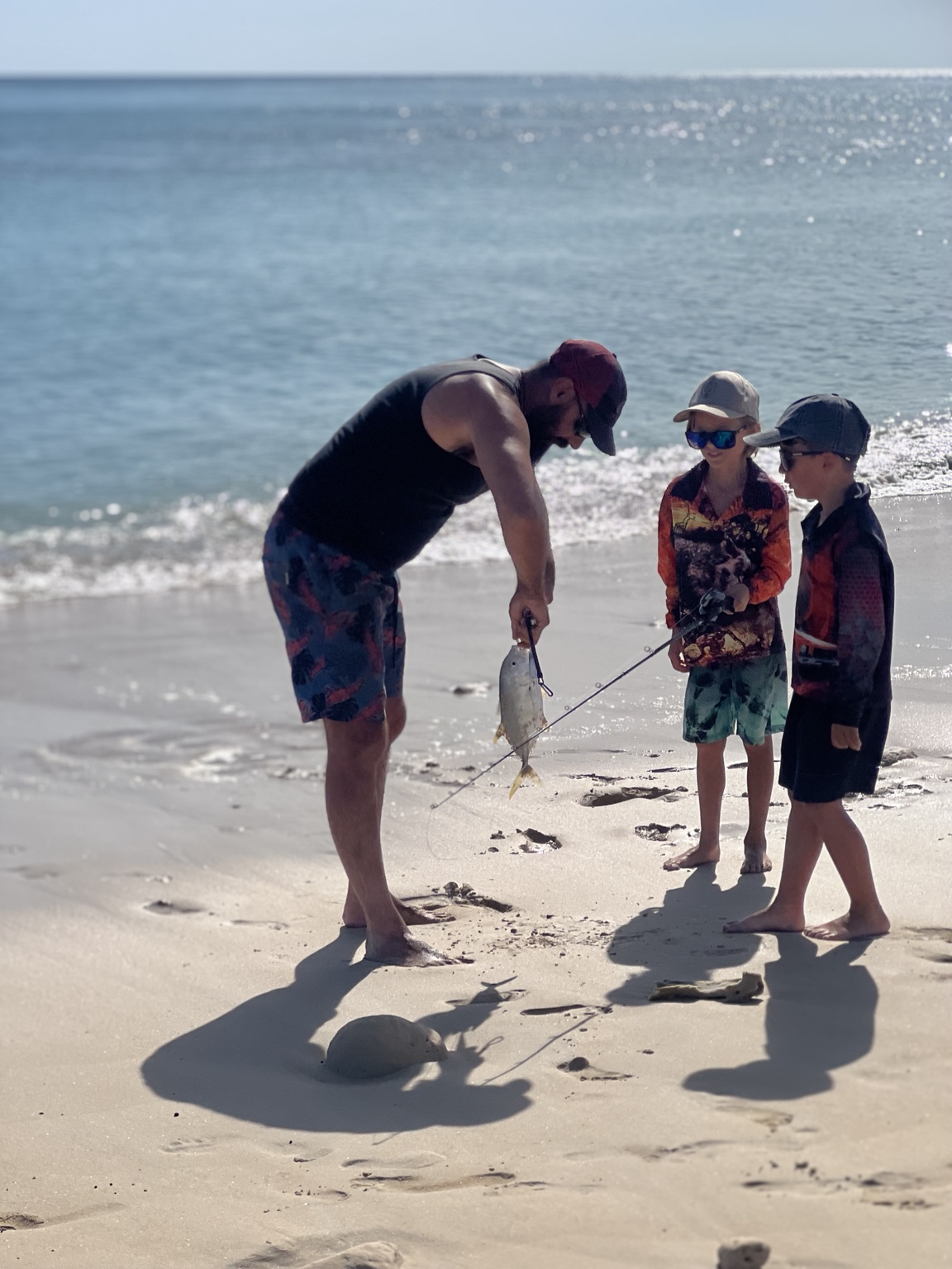Family fishing from a Cape York beach